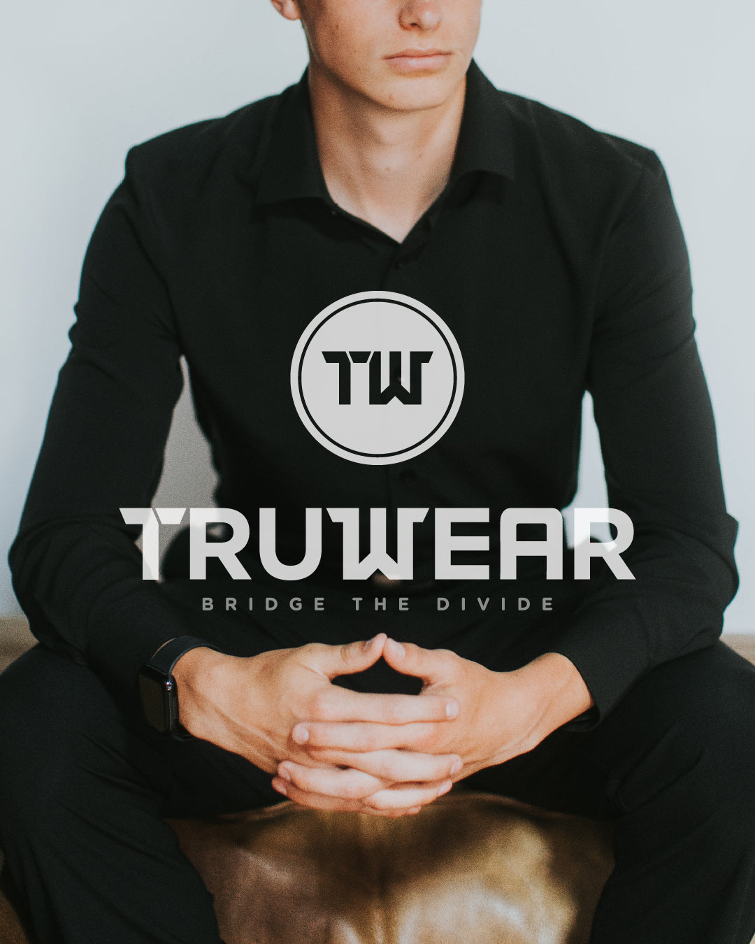 Man wearing black mens dress shirt and dress pants overlaid with Truwear logo