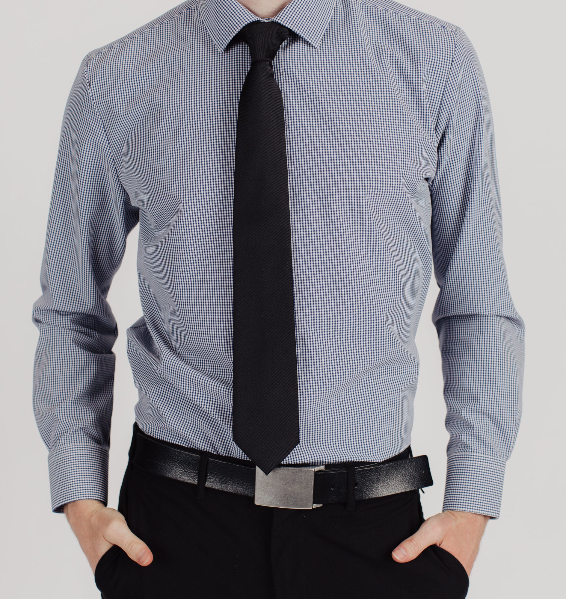 Man wearing a Truwear mens black plaid long sleeve shirt with belt and dress pants