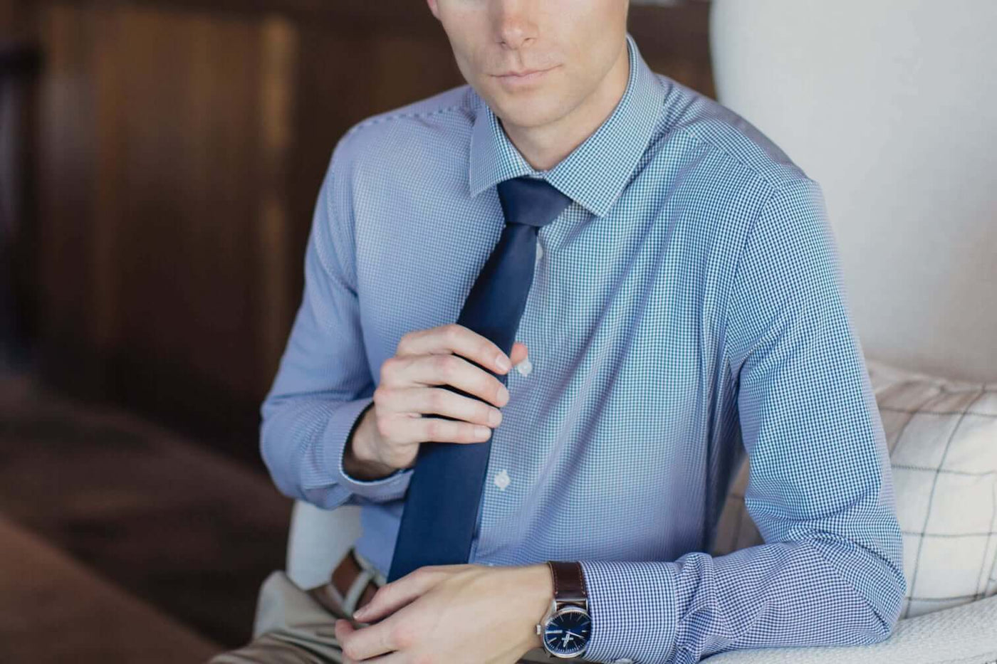 Man in Truwear checkered blue shirt with dark blue tie and nice watch